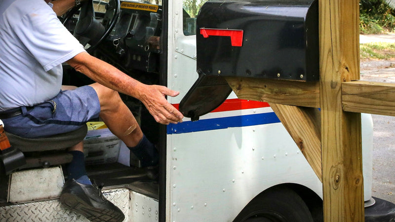 How does a mail carrier deliver to a locking mailbox?